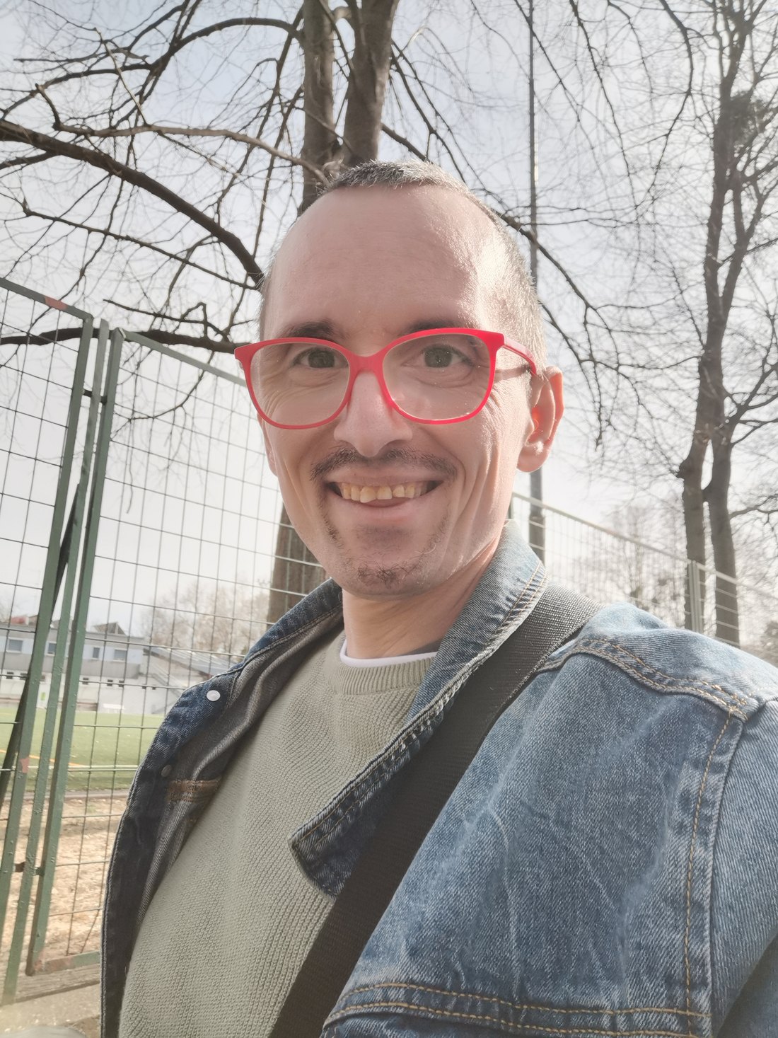 Erwin Strobl in Jeansjacke im Freien, mit seiner roten Brille